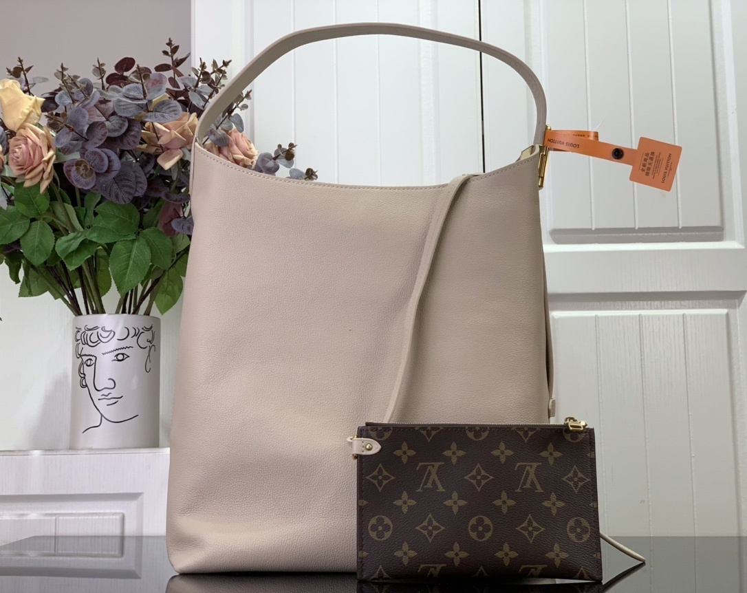 LV Low Key Hobo MM handbag in smooth grained calfskin leather and a limestone color