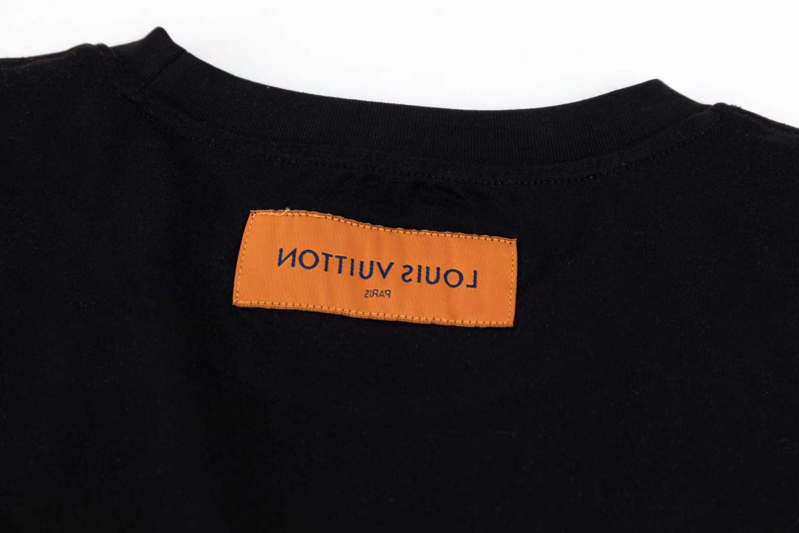 LV black short-sleeved t-shirt with a graphic of a cartoon tiger wearing sunglasses and holding a drink