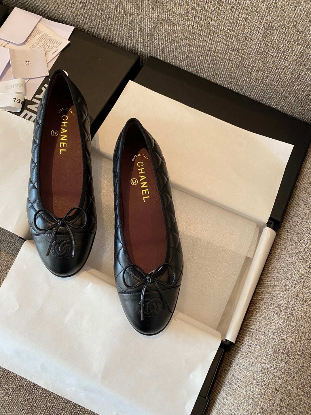 Chanel black aged calfskin quilted CC cap toe ballerina flats.