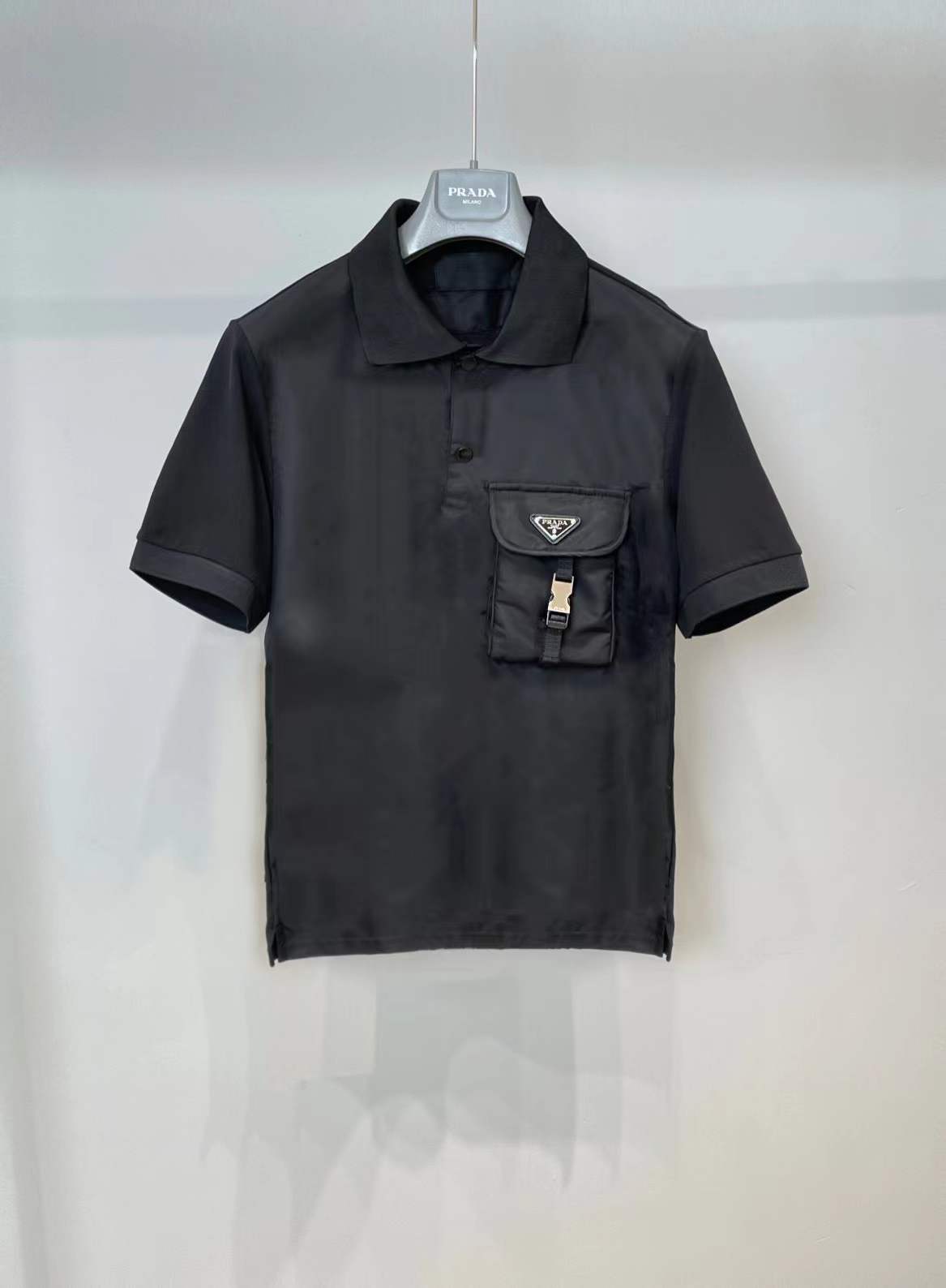 Prada men's stretch cotton polo shirt with a contrasting Re-Nylon breast pocket and the brand's iconic enameled metal triangle logo