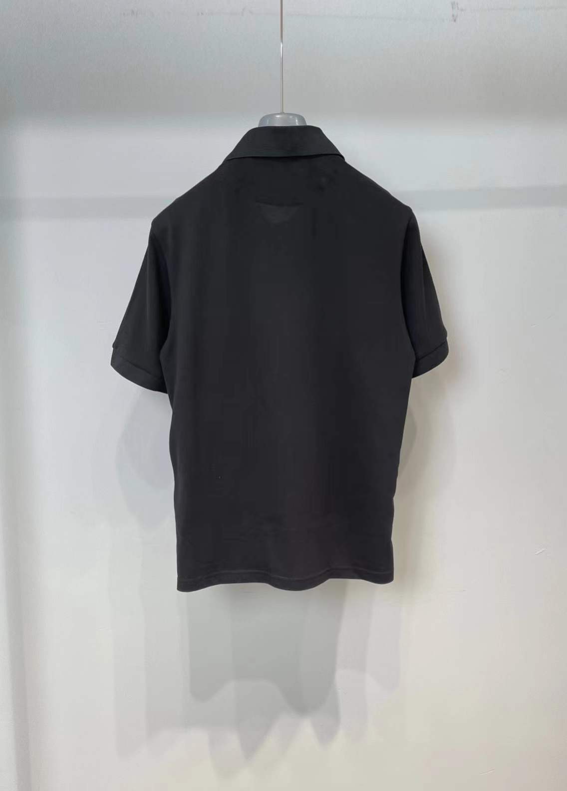 Prada men's stretch cotton polo shirt with a contrasting Re-Nylon breast pocket and the brand's iconic enameled metal triangle logo