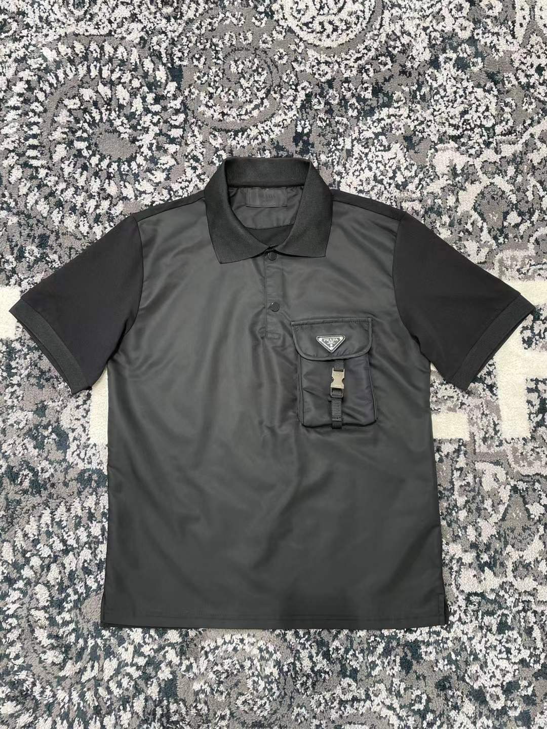 Prada men's stretch cotton polo shirt with a contrasting Re-Nylon breast pocket and the brand's iconic enameled metal triangle logo