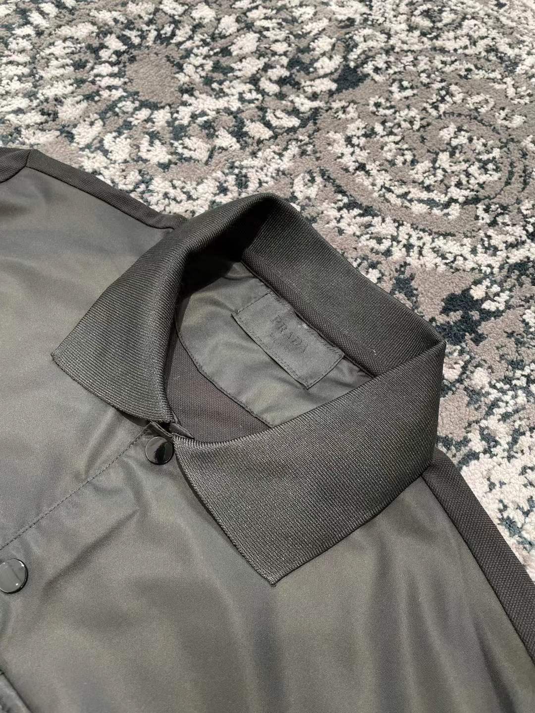 Prada men's stretch cotton polo shirt with a contrasting Re-Nylon breast pocket and the brand's iconic enameled metal triangle logo