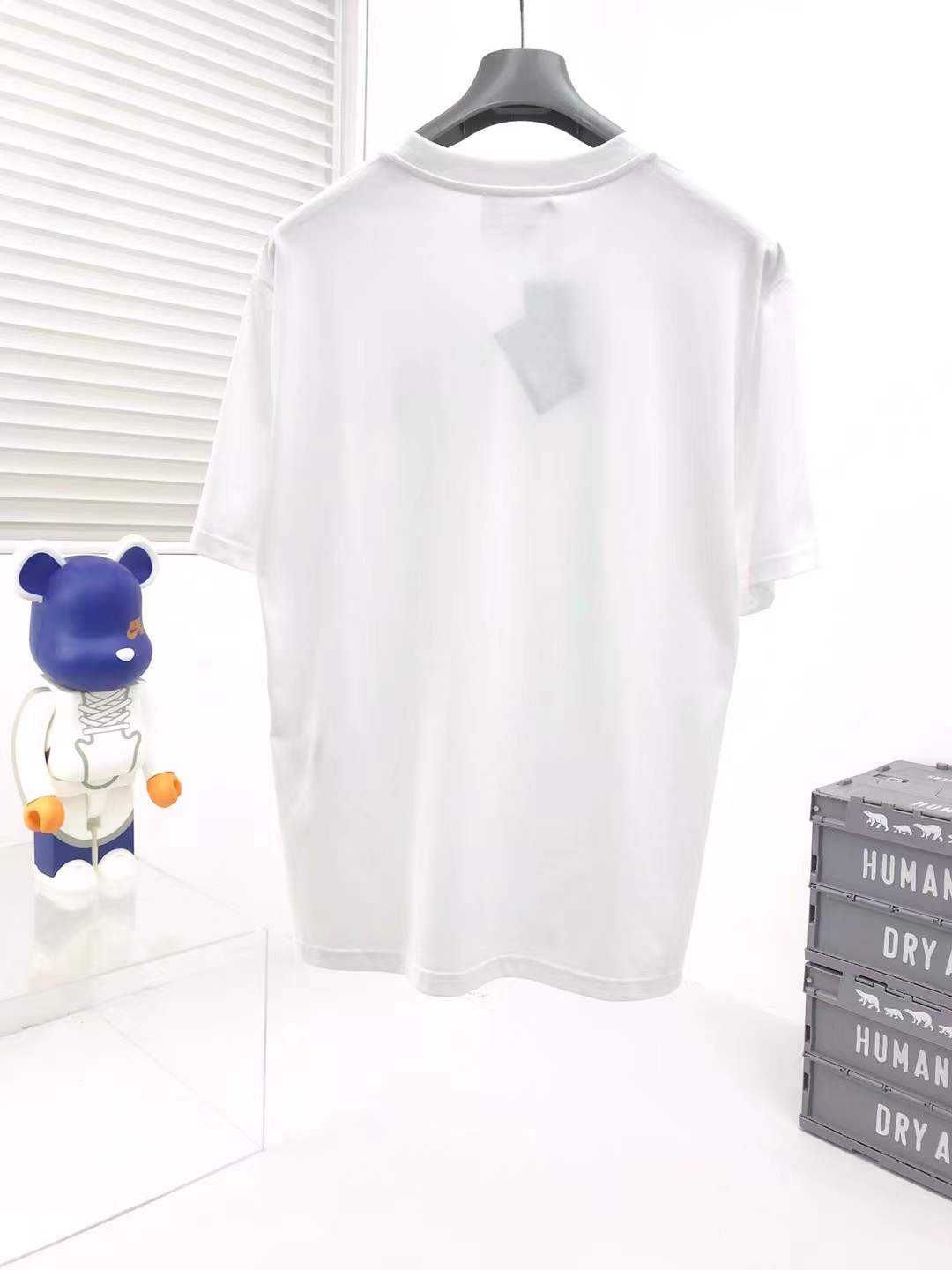 Prada cotton t-shirt white featuring the brand's iconic enameled metal triangle logo on the chest.