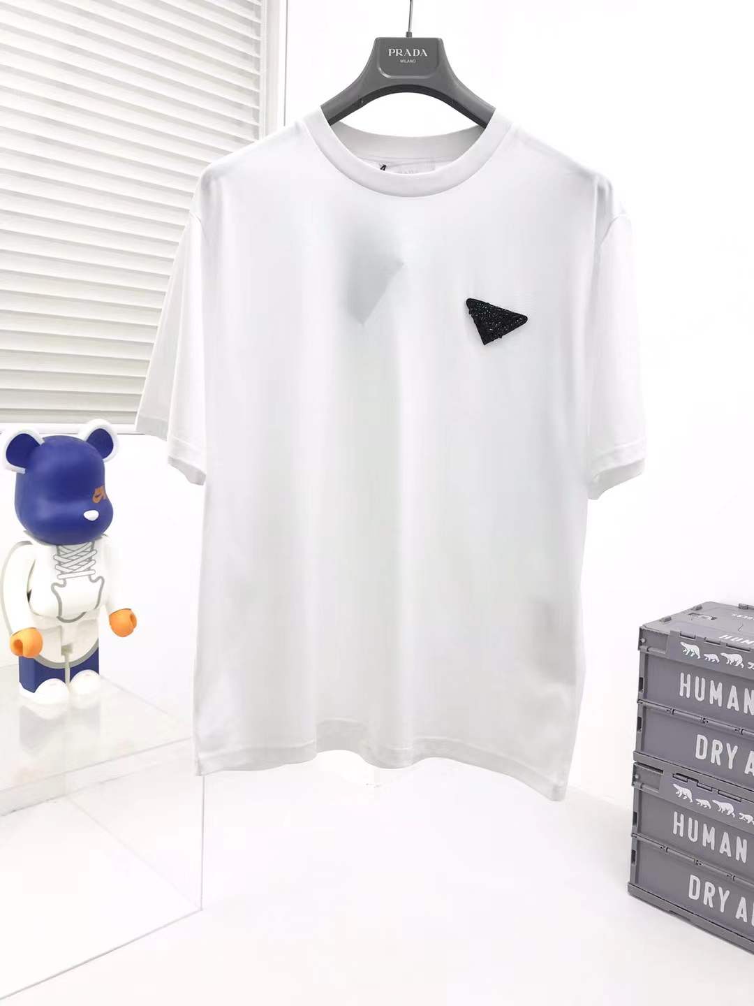 Prada cotton t-shirt white featuring the brand's iconic enameled metal triangle logo on the chest.