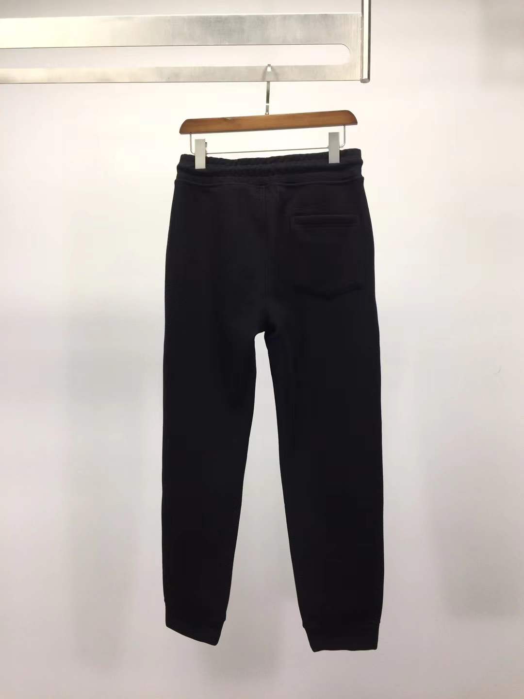 Moncler Black sweatpants with a white vertical logo print on the leg