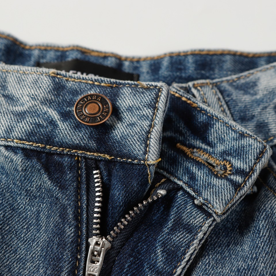 Balenciaga denim shorts featuring a "Paris" graphic and a sunset scene