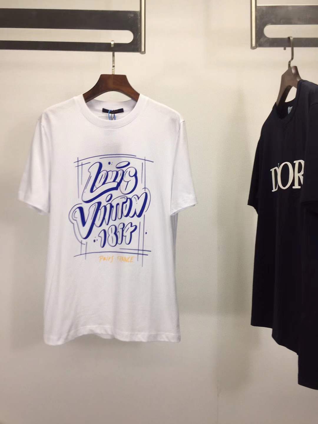 LV T-shirt featuring a blue graphic print that includes the brand name, "1854", and "PARIS. FRANCE".