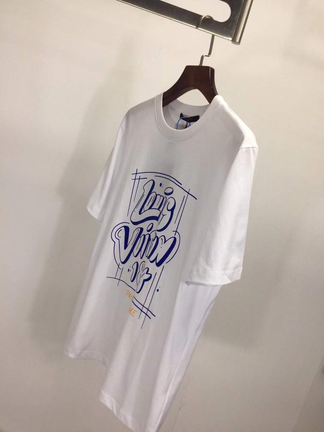 LV T-shirt featuring a blue graphic print that includes the brand name, "1854", and "PARIS. FRANCE".