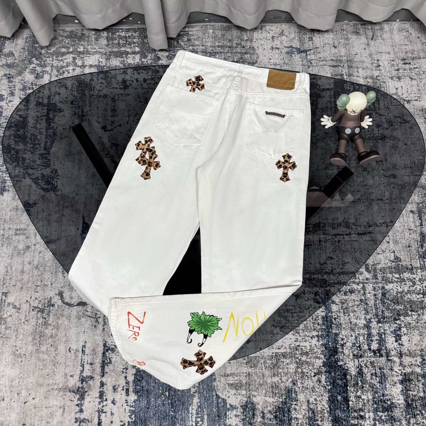 Chrome Hearts Matty Boy custom painted Levi's cross patch jeans in white denim with leopard print crosses.