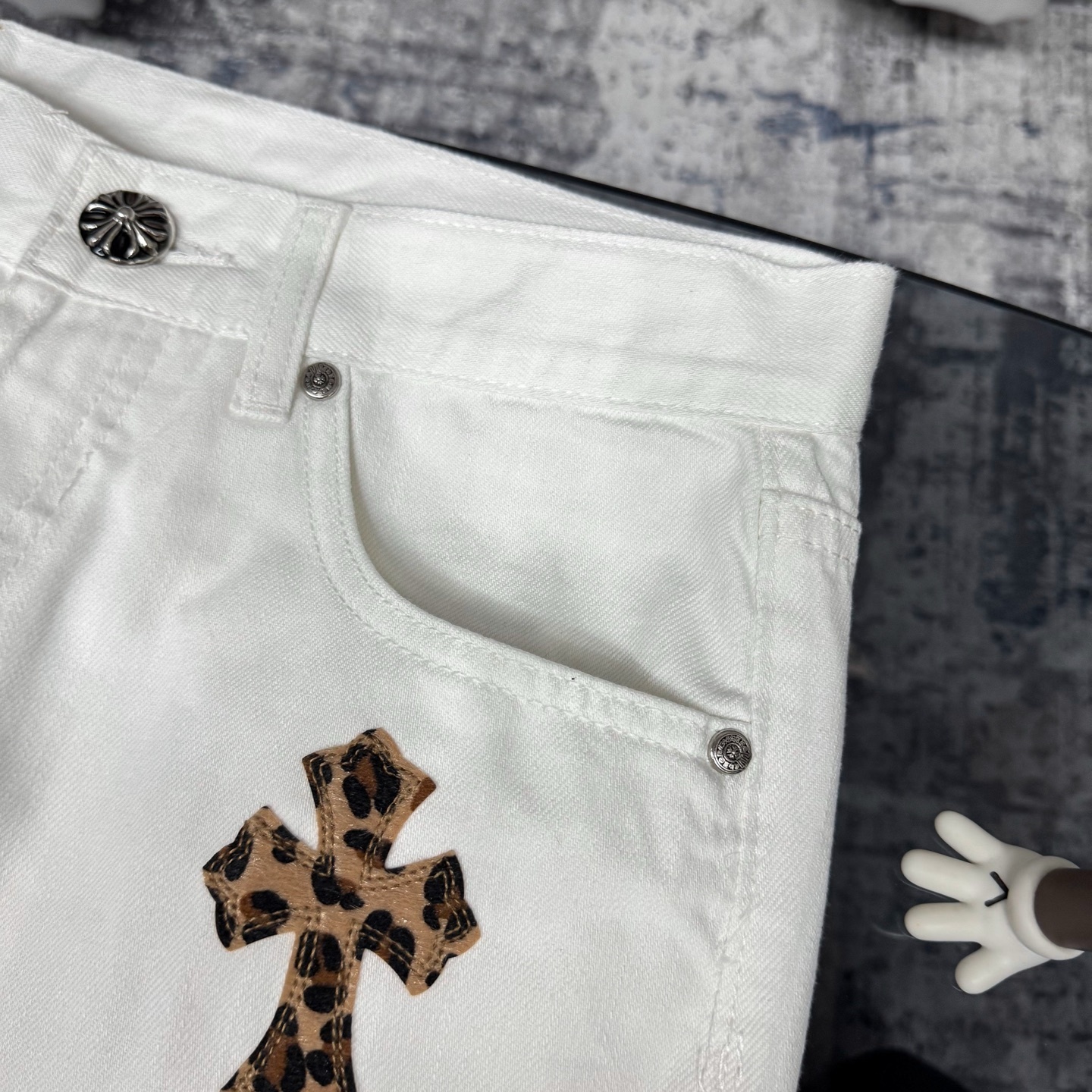 Chrome Hearts Matty Boy custom painted Levi's cross patch jeans in white denim with leopard print crosses.