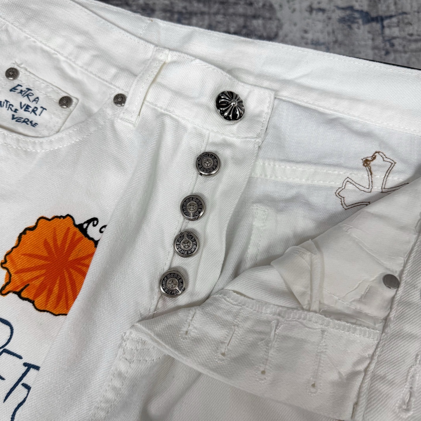 Chrome Hearts Matty Boy custom painted Levi's cross patch jeans in white denim with leopard print crosses.