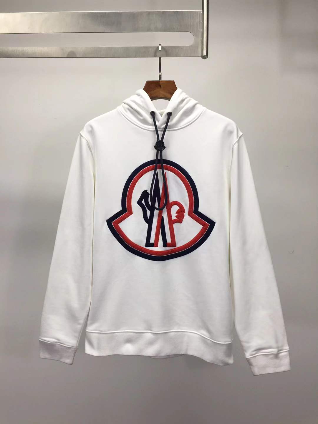 Moncler cotton hoodie with a large, two-tone embroidered logo on the front