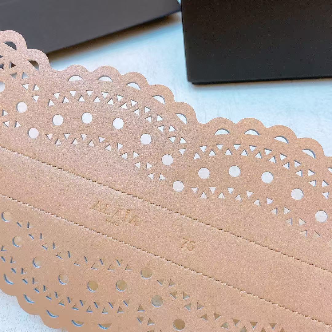 Alaïa black leather laser-cut waist belt.