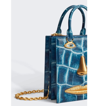 Schiaparelli Face Bag in blue calfskin with crocodile-effect embossing and anatomical jewels in enamel and hammered gold-plated brass.