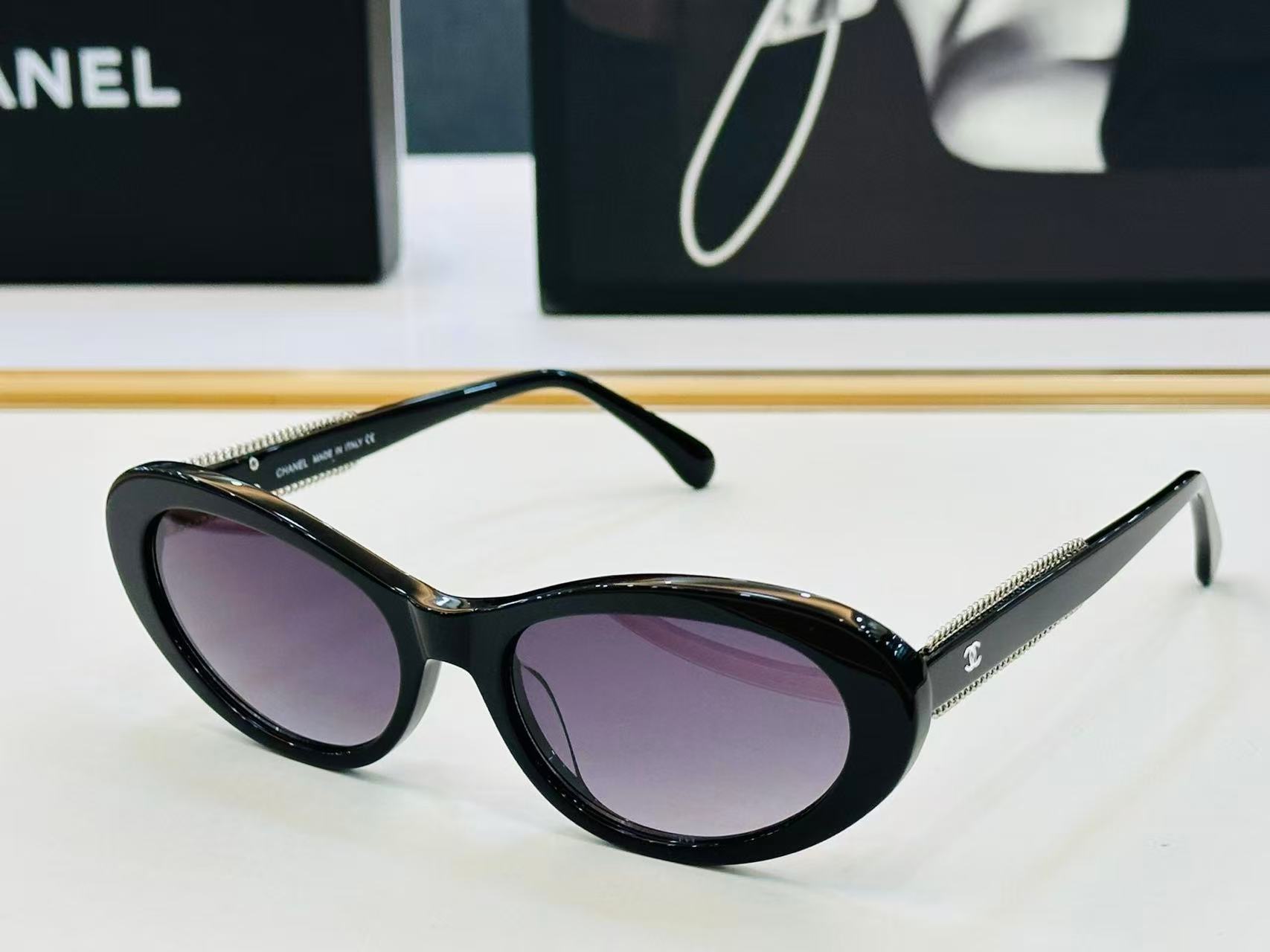 Chanel CH5515 oval sunglasses in black acetate with black lenses.