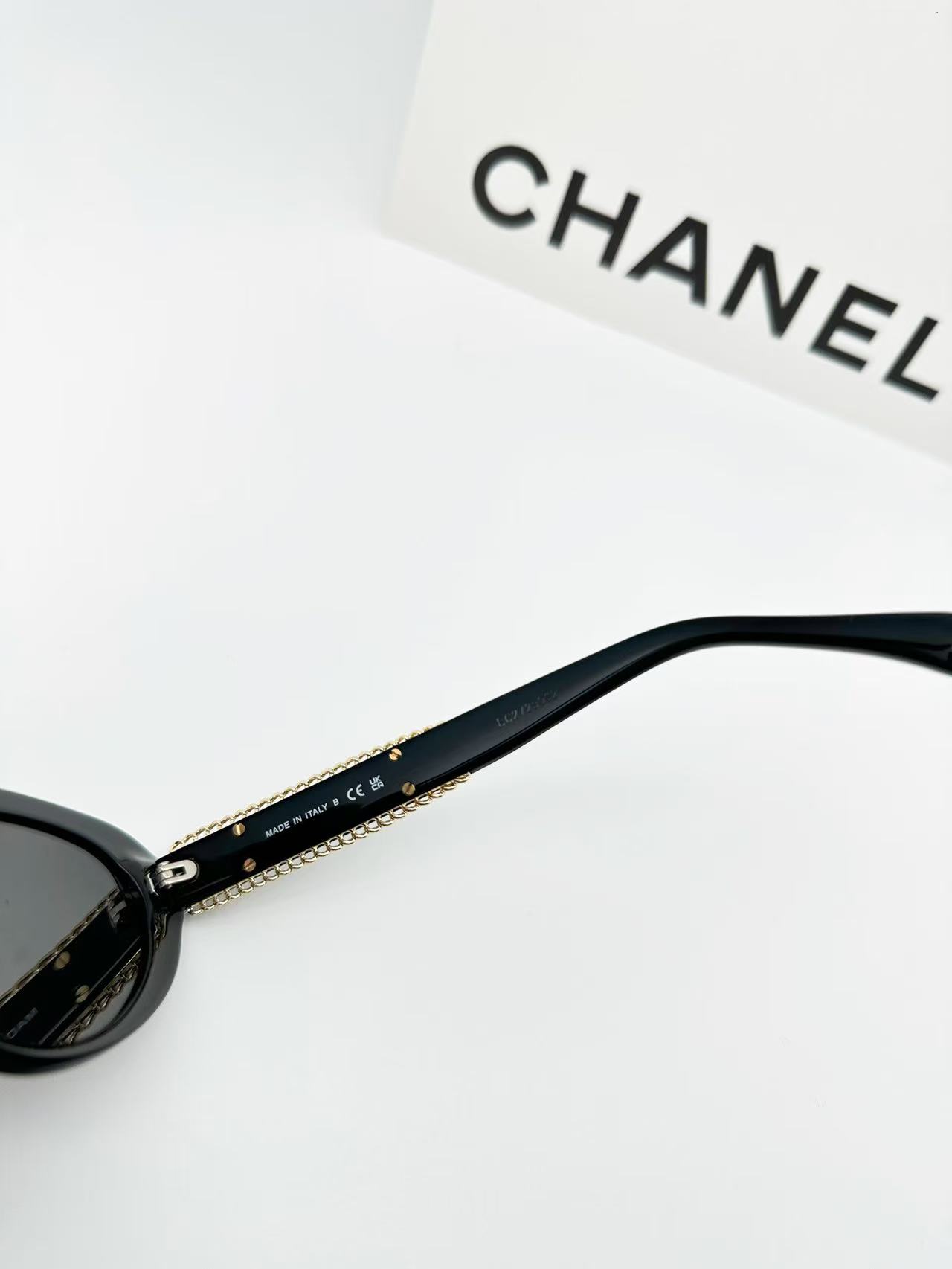 Chanel CH5515 oval sunglasses in black acetate with black lenses.