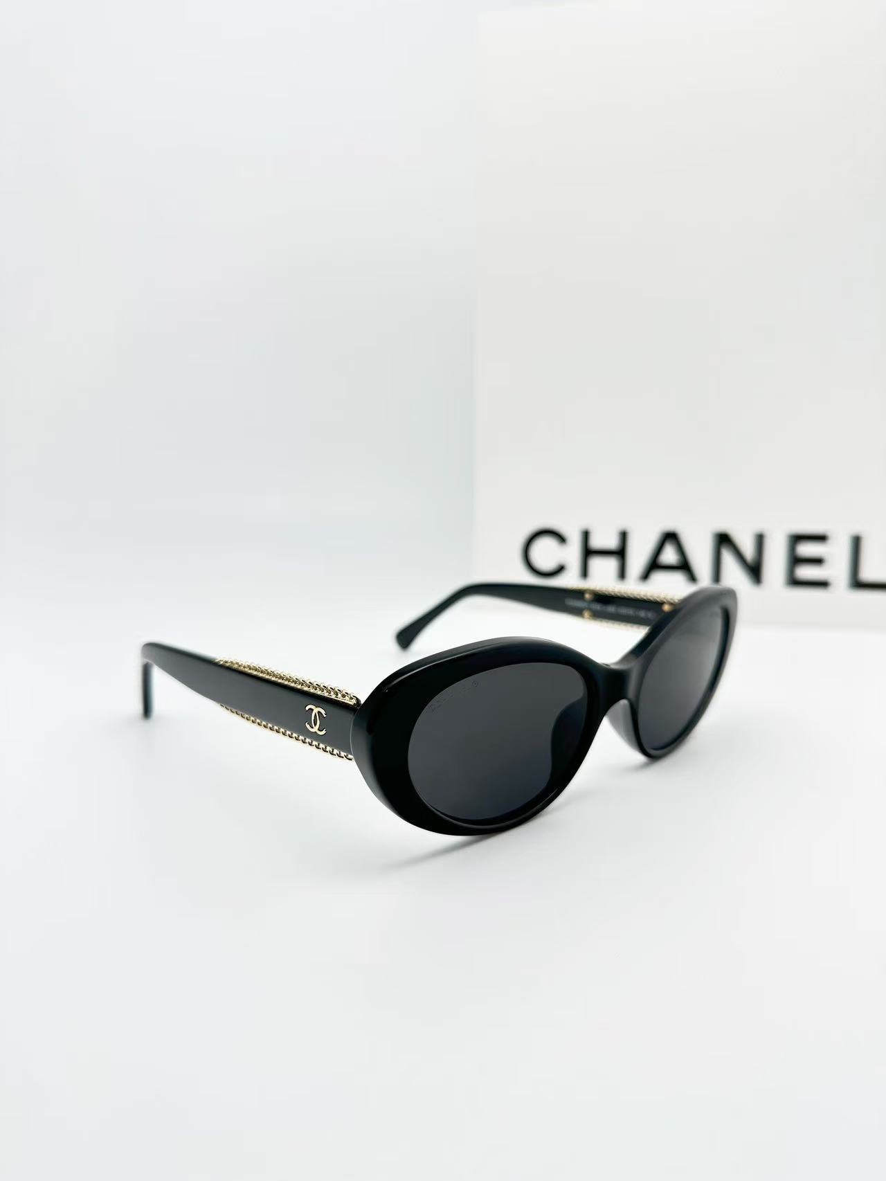 Chanel CH5515 oval sunglasses in black acetate with black lenses.
