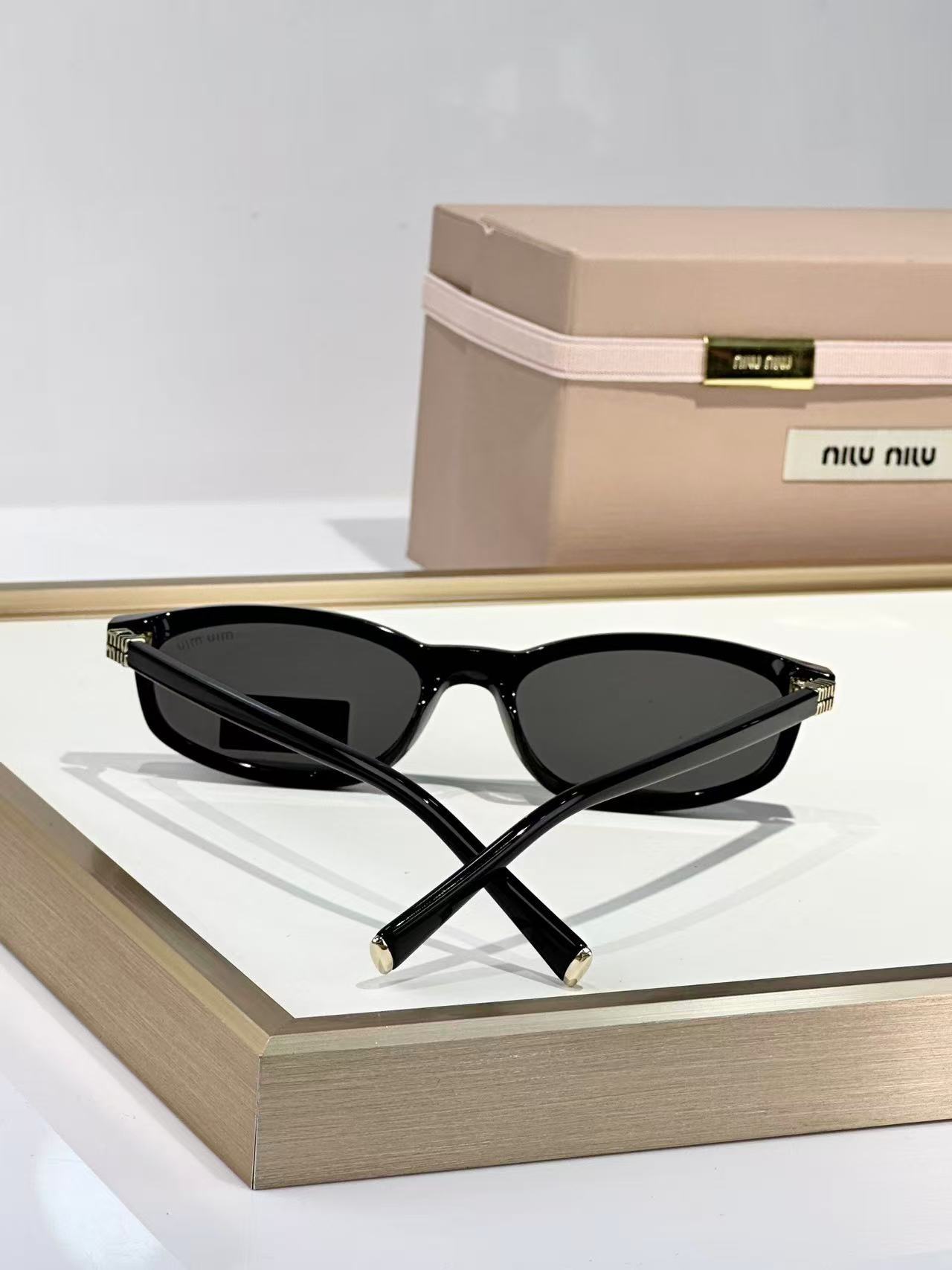 Miu Miu Sunglasses in black with grey