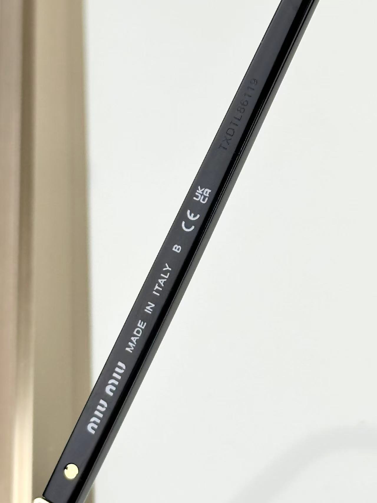 Miu Miu Sunglasses in black with grey