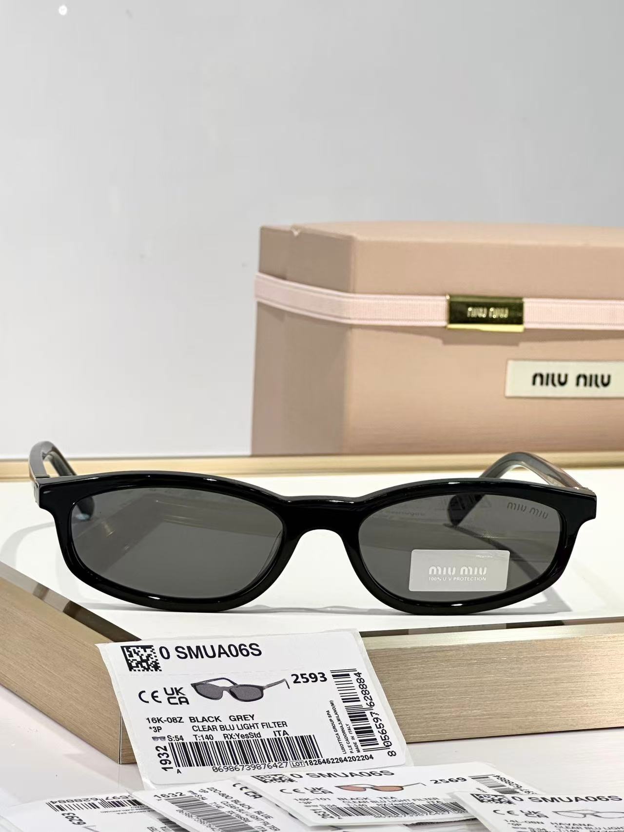 Miu Miu Sunglasses in black with grey