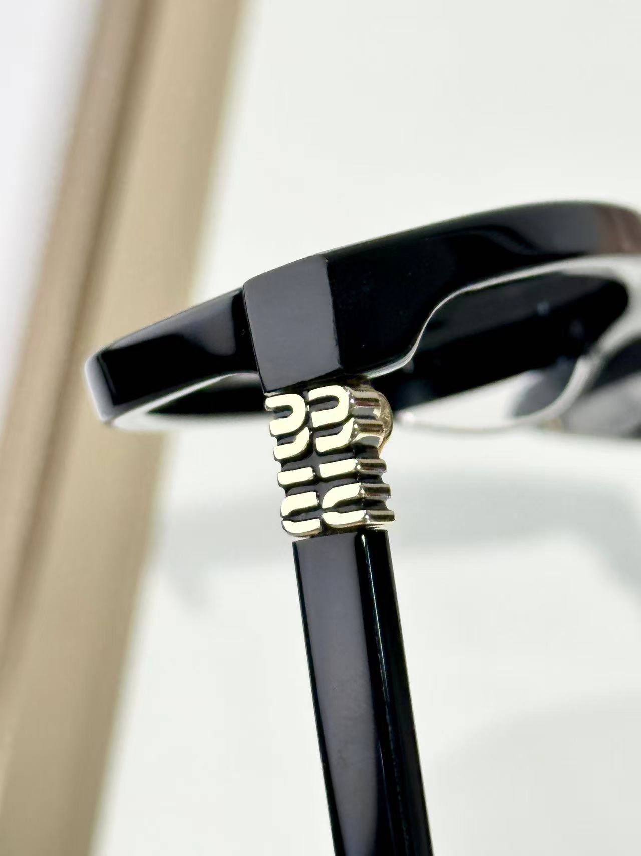 Miu Miu Sunglasses in black with grey