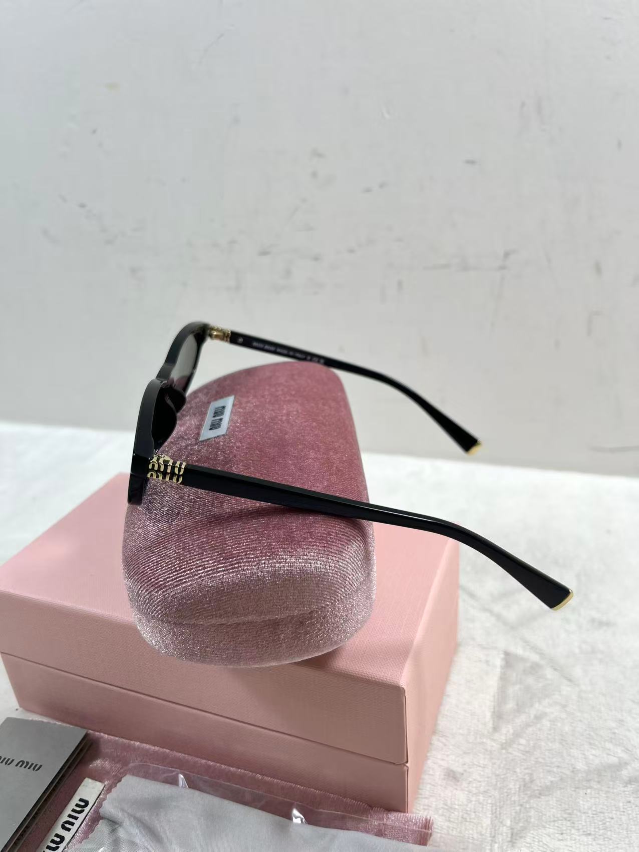 Miu Miu MU A06S black acetate oval sunglasses