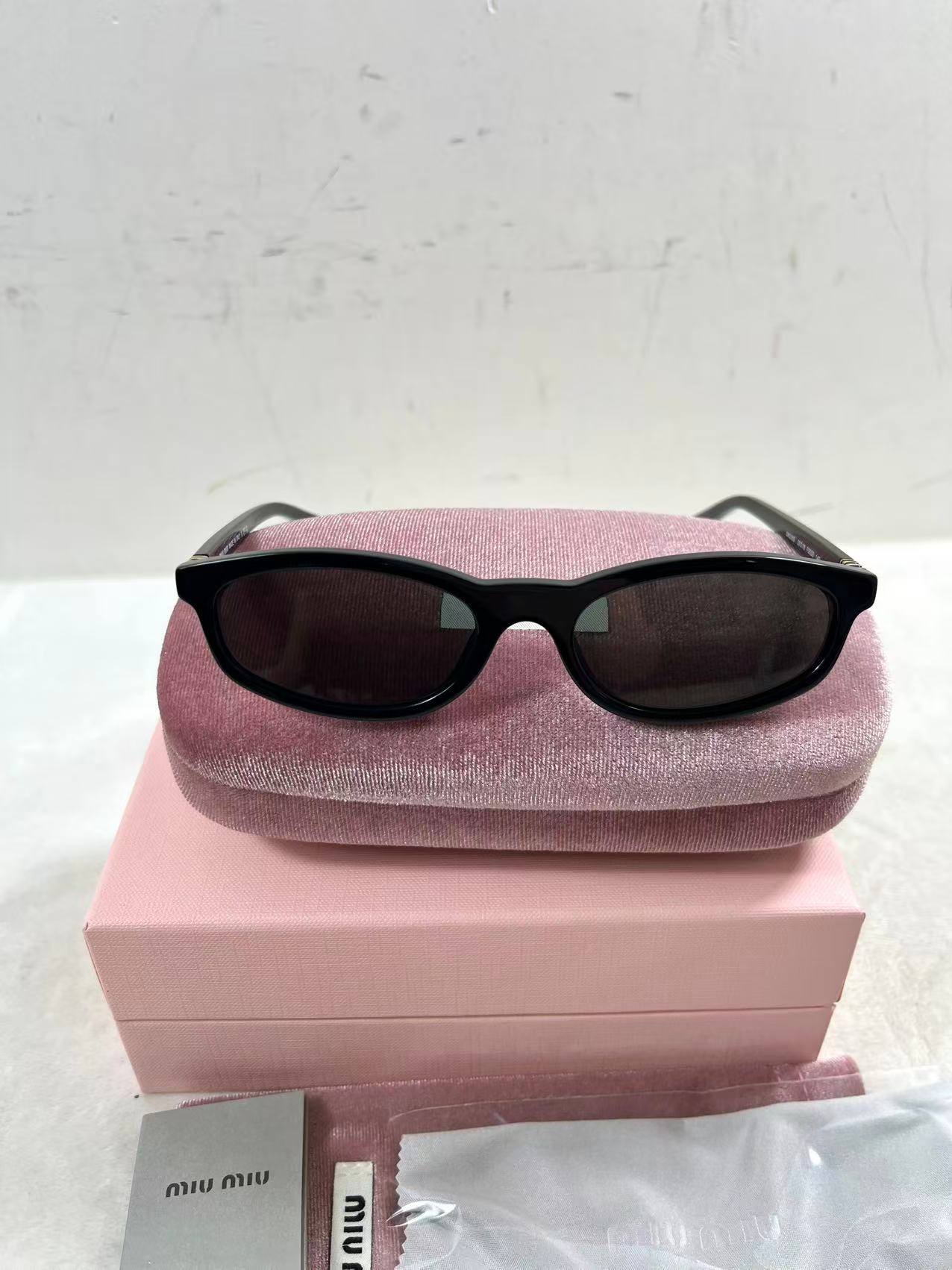 Miu Miu MU A06S black acetate oval sunglasses