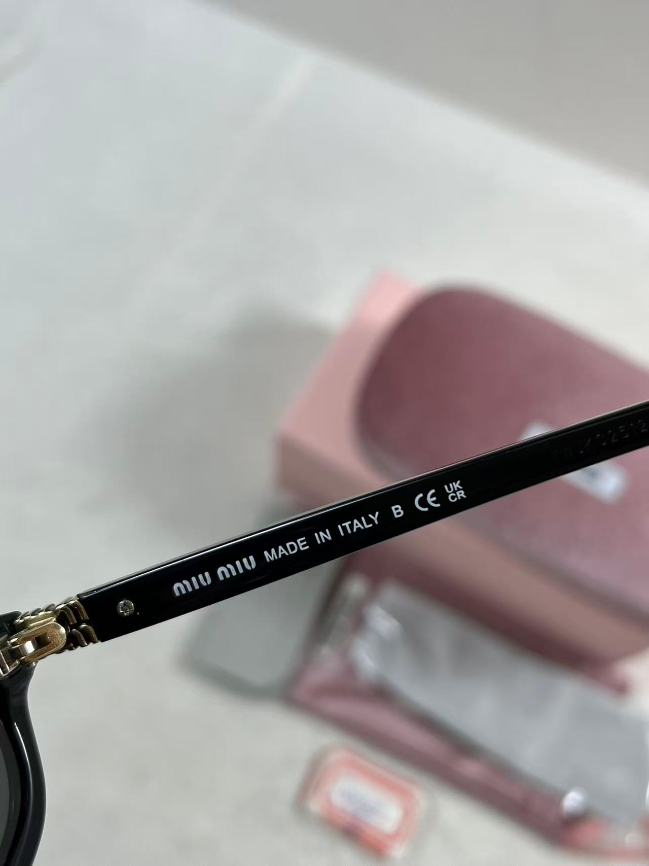 Miu Miu MU A06S black acetate oval sunglasses