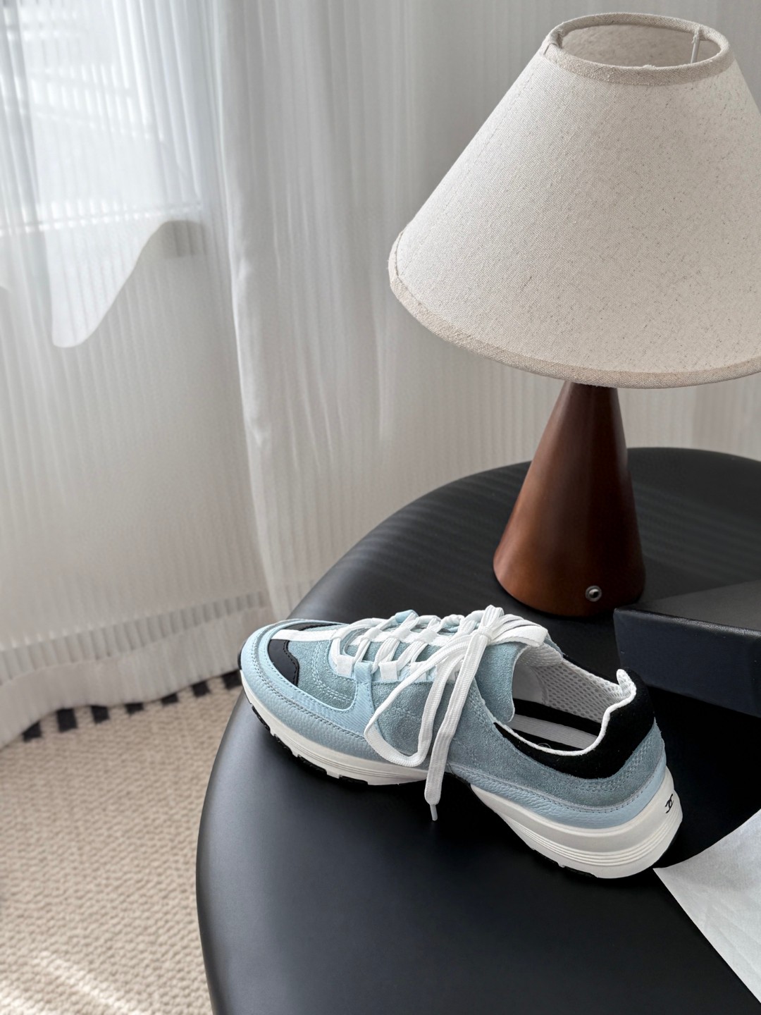 Chanel light blue and black Chanel suede calfskin grosgrain CC sneakers distinctive black CC logo on the side.