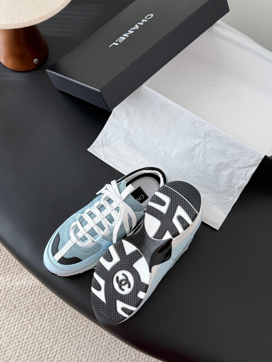 Chanel light blue and black Chanel suede calfskin grosgrain CC sneakers distinctive black CC logo on the side.