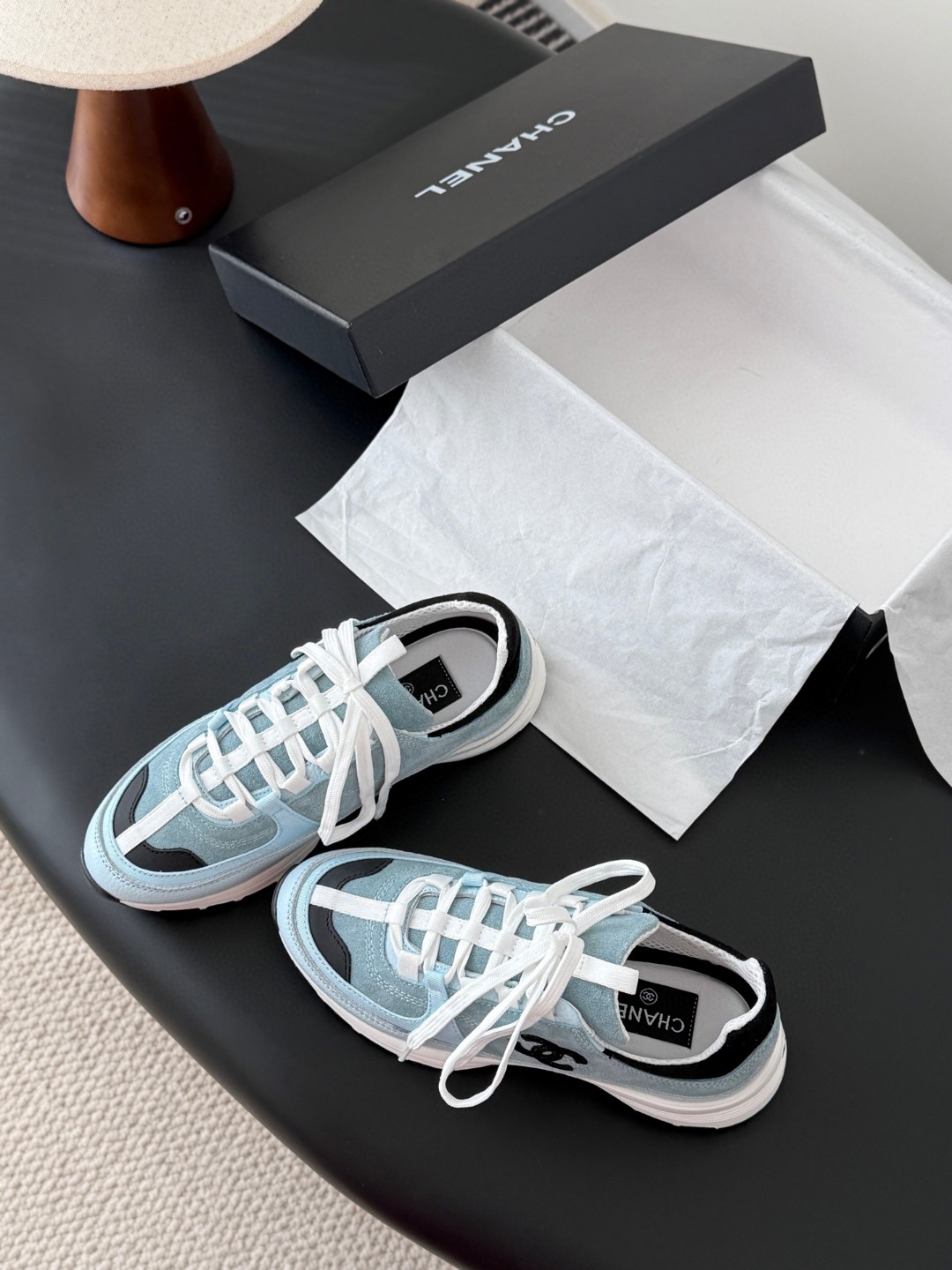 Chanel light blue and black Chanel suede calfskin grosgrain CC sneakers distinctive black CC logo on the side.