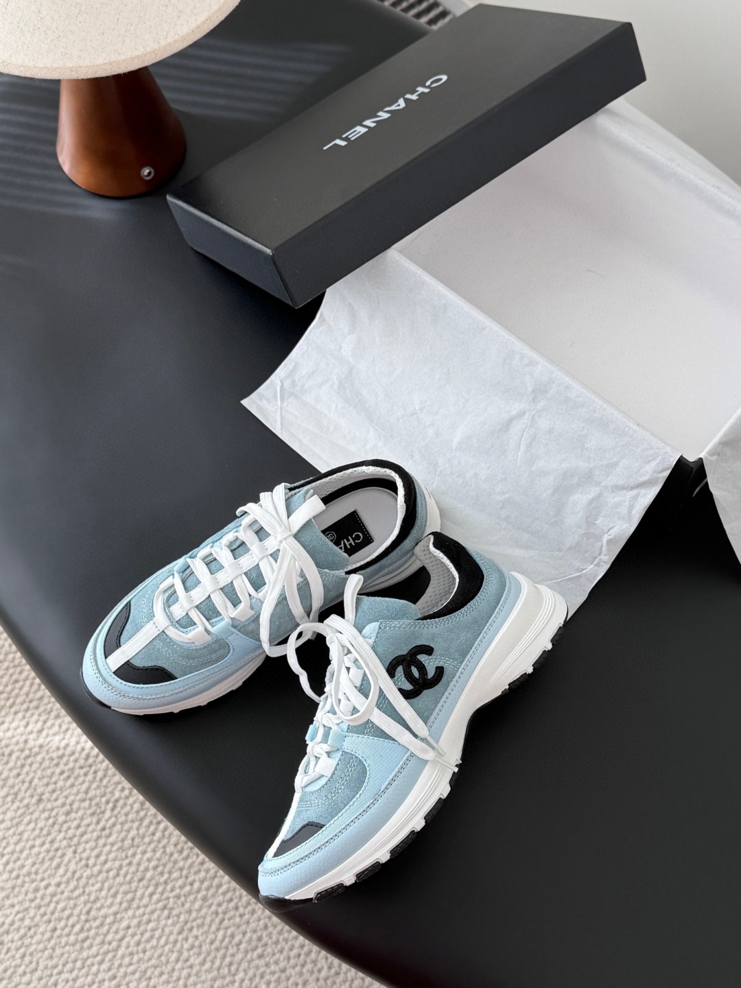 Chanel light blue and black Chanel suede calfskin grosgrain CC sneakers distinctive black CC logo on the side.