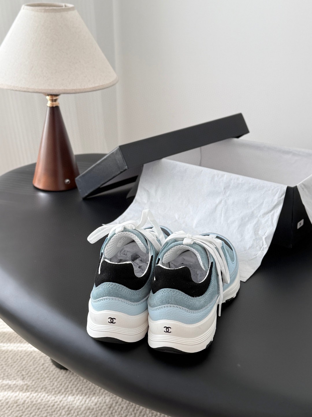 Chanel light blue and black Chanel suede calfskin grosgrain CC sneakers distinctive black CC logo on the side.