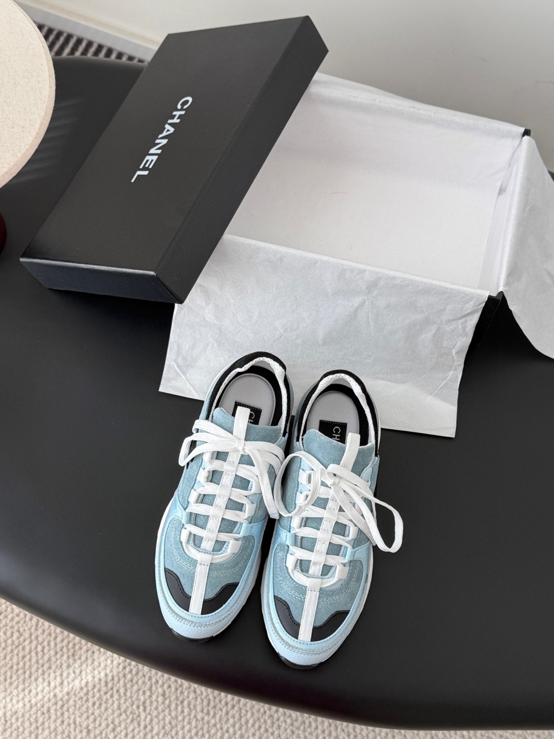 Chanel light blue and black Chanel suede calfskin grosgrain CC sneakers distinctive black CC logo on the side.