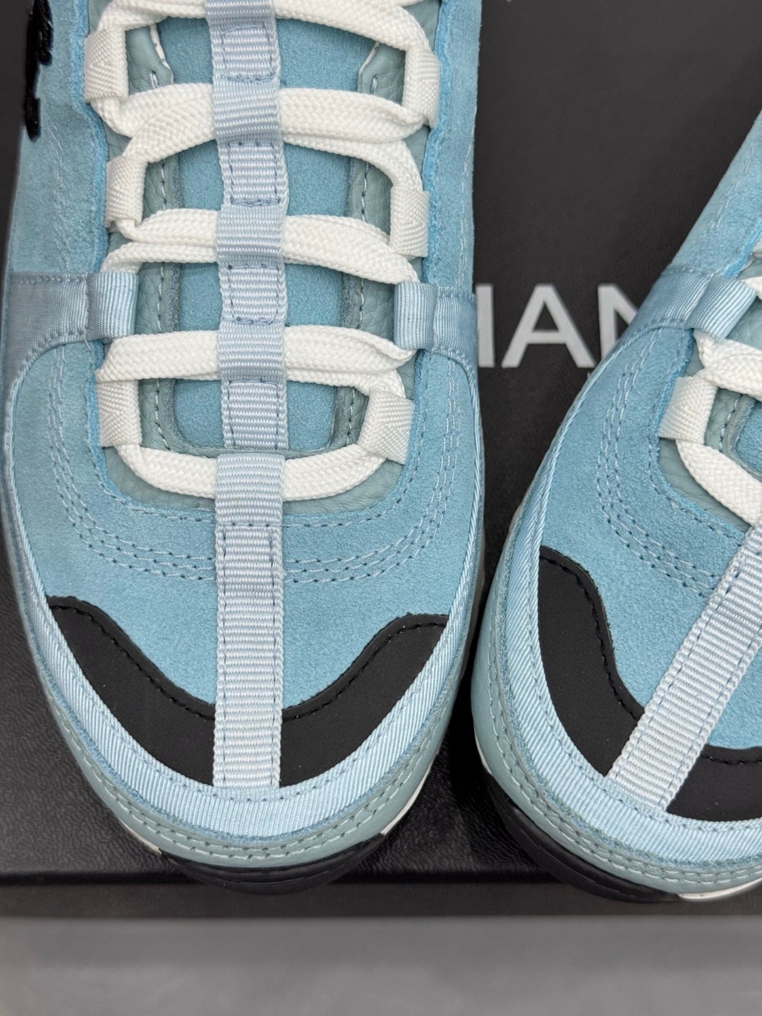 Chanel light blue and black Chanel suede calfskin grosgrain CC sneakers distinctive black CC logo on the side.