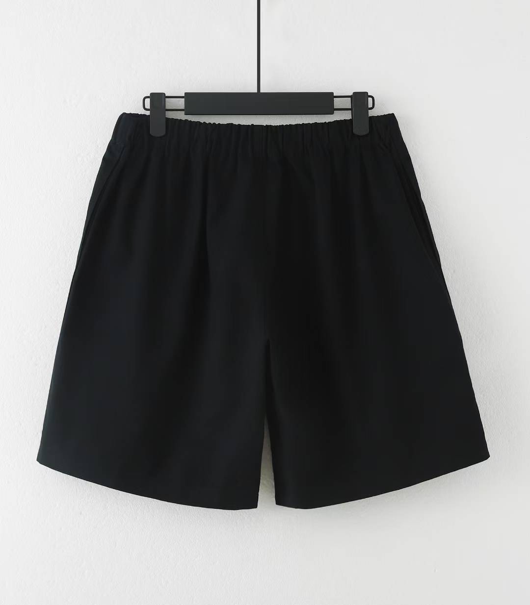Balenciaga Property Baggy Shorts in black, featuring a logo print on the leg.