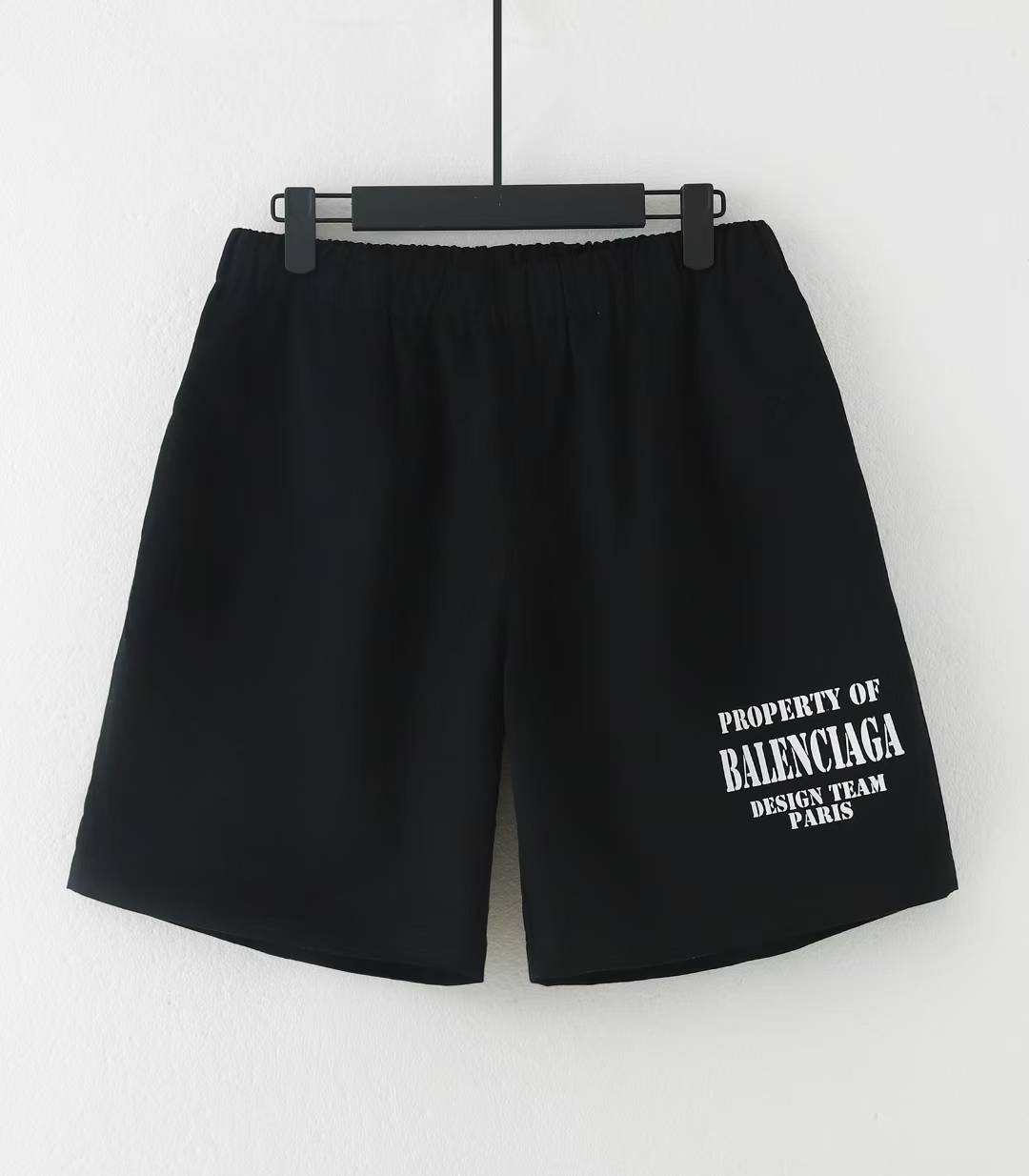 Balenciaga Property Baggy Shorts in black, featuring a logo print on the leg.