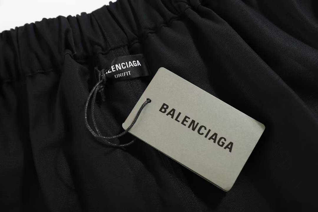 Balenciaga Property Baggy Shorts in black, featuring a logo print on the leg.