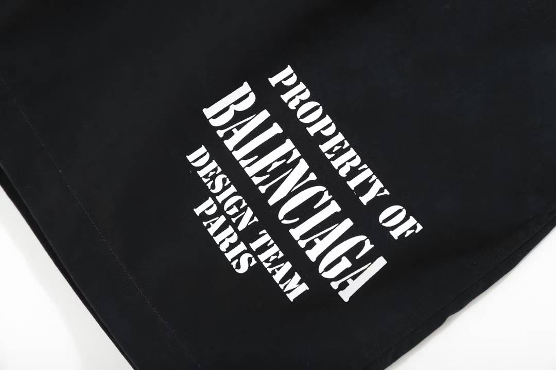 Balenciaga Property Baggy Shorts in black, featuring a logo print on the leg.
