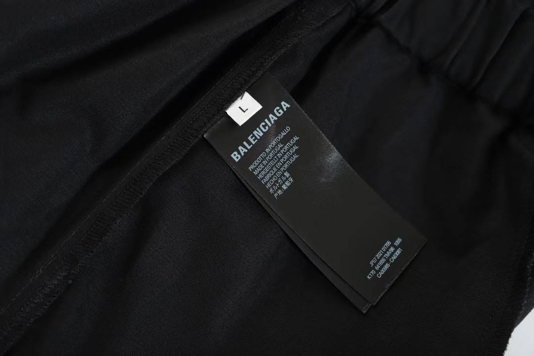 Balenciaga Property Baggy Shorts in black, featuring a logo print on the leg.