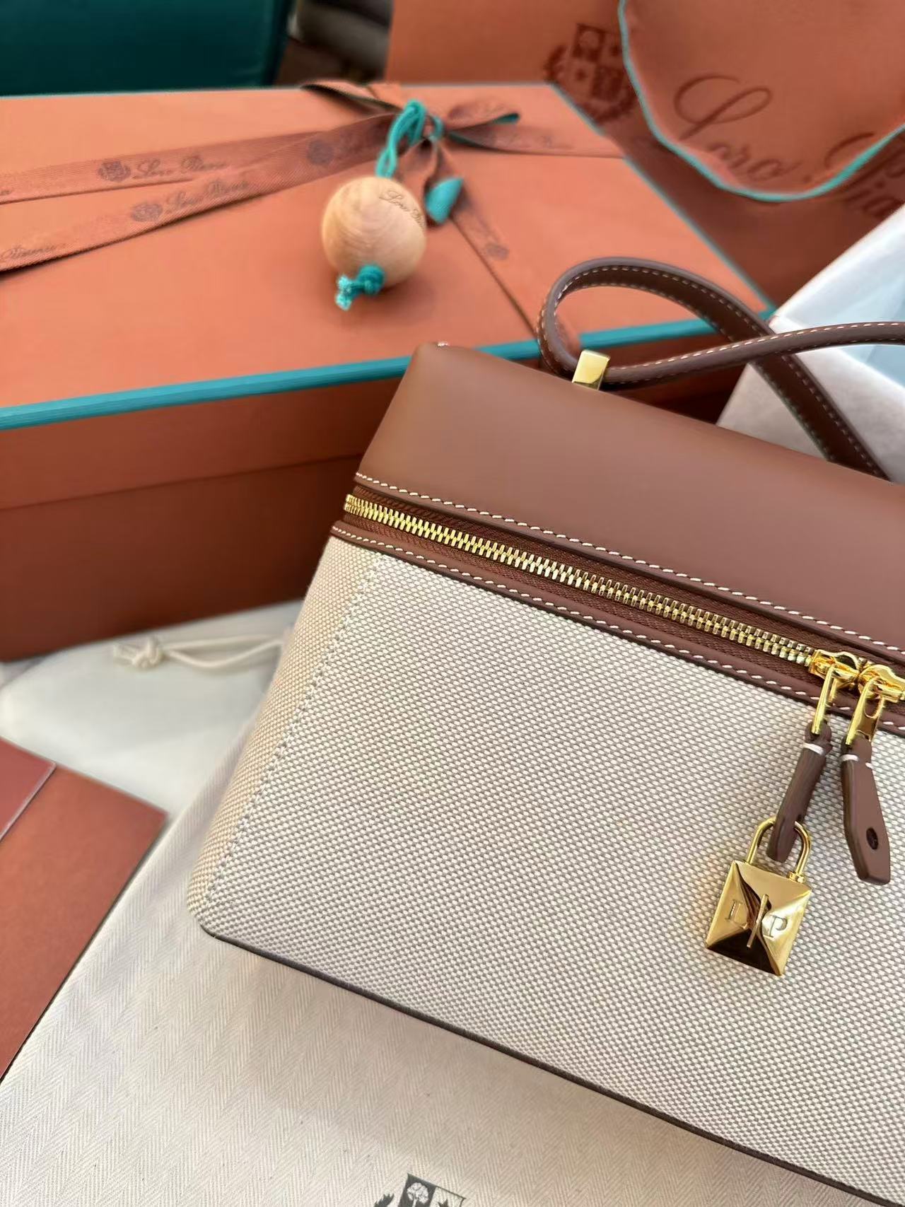 Loro Piana Extra Bag L27 in a natural/caramel sugar colorway cotton and linen blend with leather trim