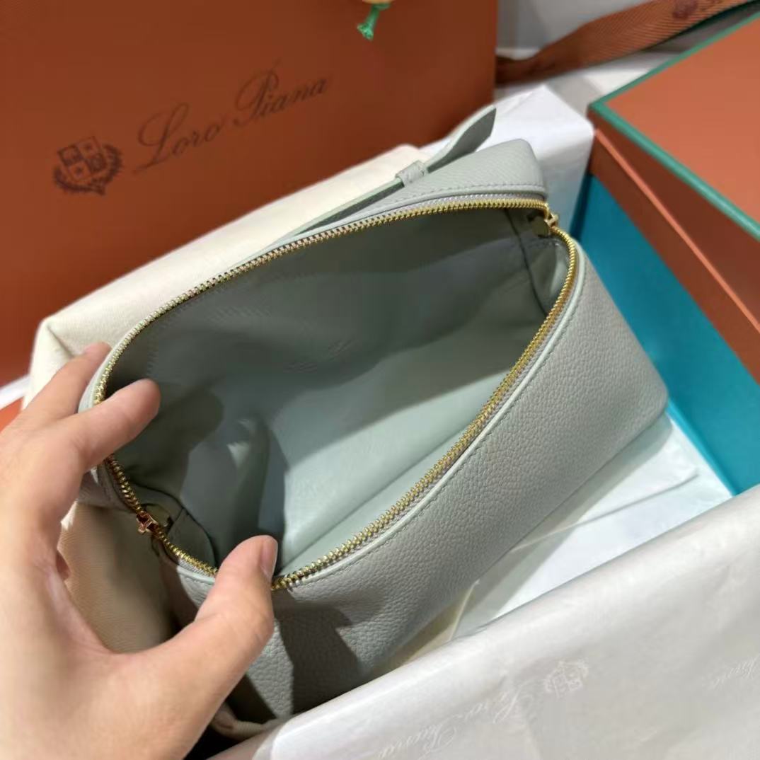 Loro Piana Extra Pocket L19 pouch in light blue is crafted from luxurious leather and features radiant sun gold hardware