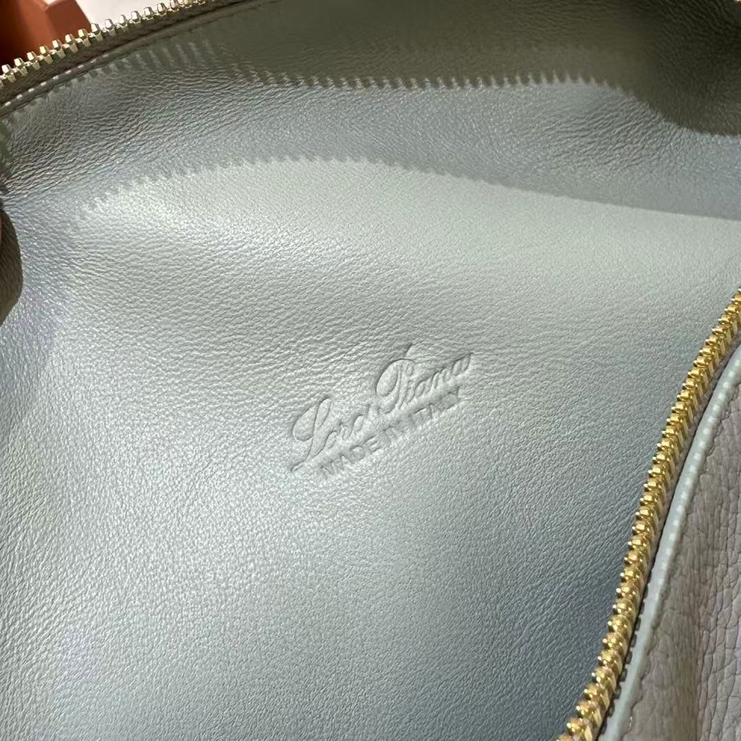 Loro Piana Extra Pocket L19 pouch in light blue is crafted from luxurious leather and features radiant sun gold hardware