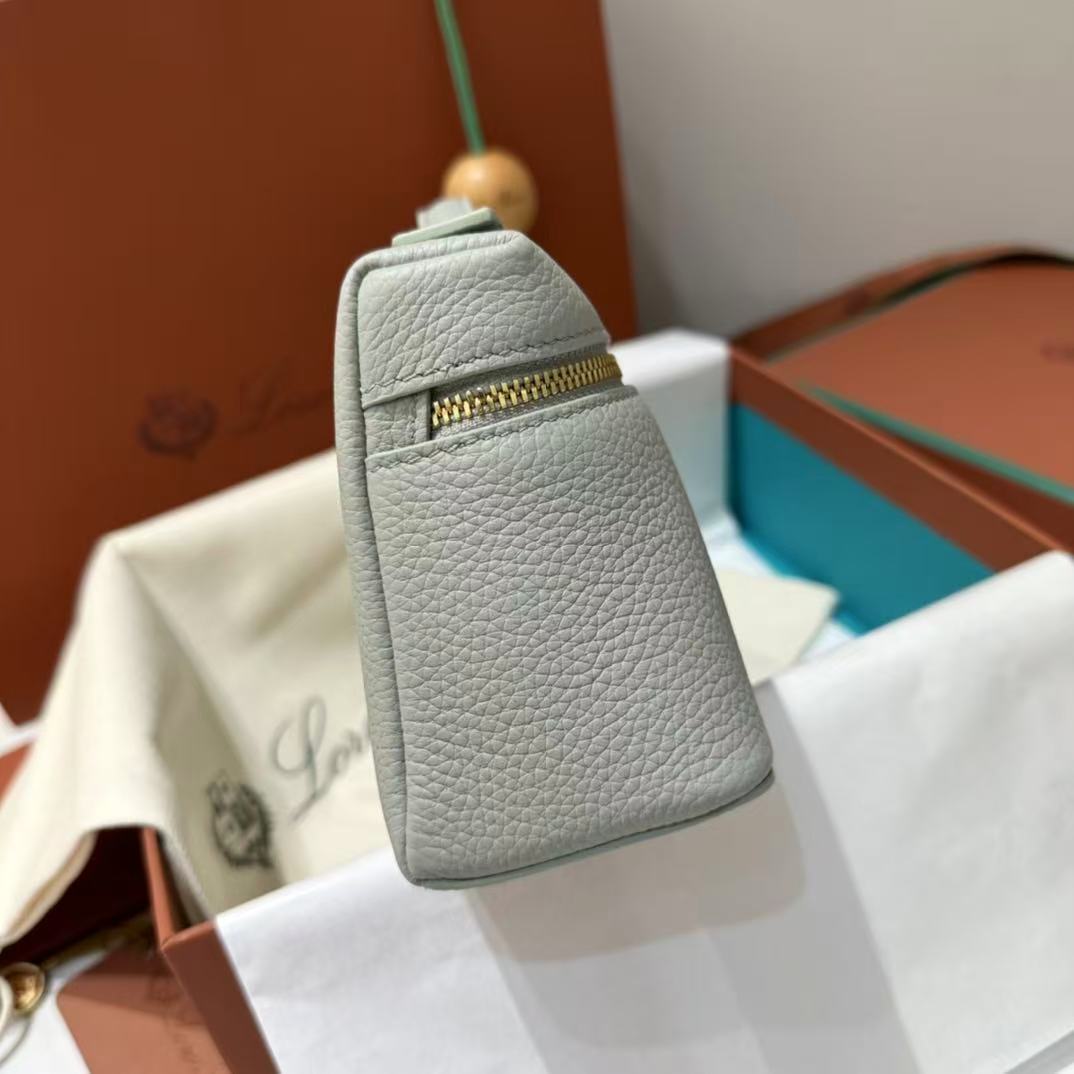 Loro Piana Extra Pocket L19 pouch in light blue is crafted from luxurious leather and features radiant sun gold hardware