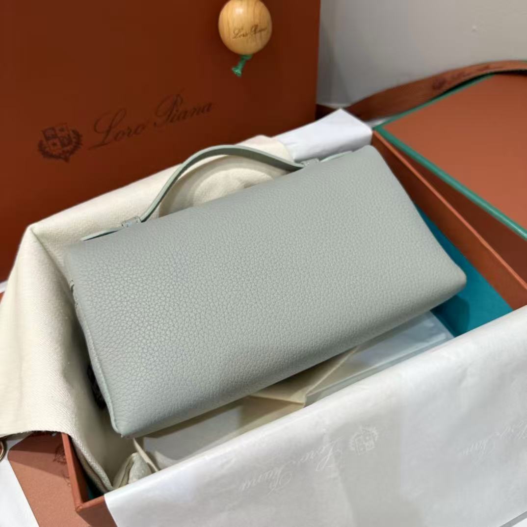 Loro Piana Extra Pocket L19 pouch in light blue is crafted from luxurious leather and features radiant sun gold hardware