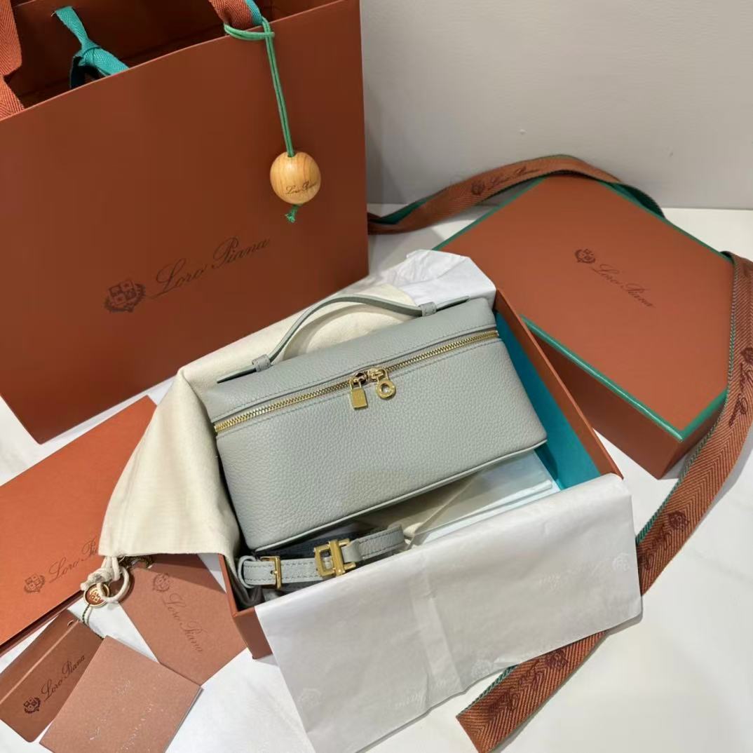 Loro Piana Extra Pocket L19 pouch in light blue is crafted from luxurious leather and features radiant sun gold hardware