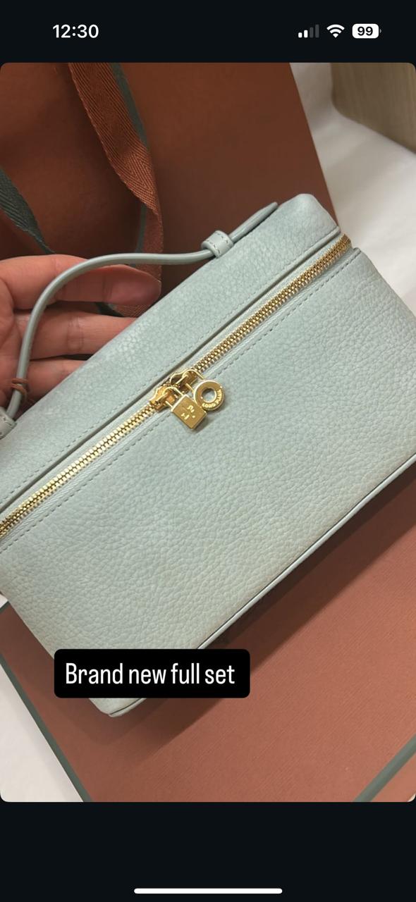 Loro Piana Extra Pocket L19 pouch in light blue is crafted from luxurious leather and features radiant sun gold hardware