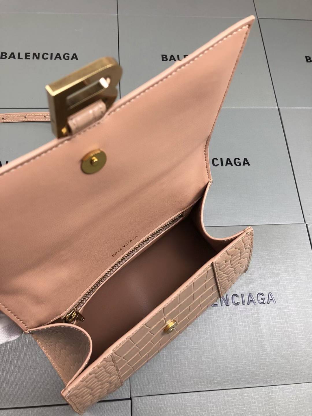 Balenciaga Hourglass handbag likely the Small or XS model, crafted from beige crocodile-embossed leather and featuring the signature B logo plaque
