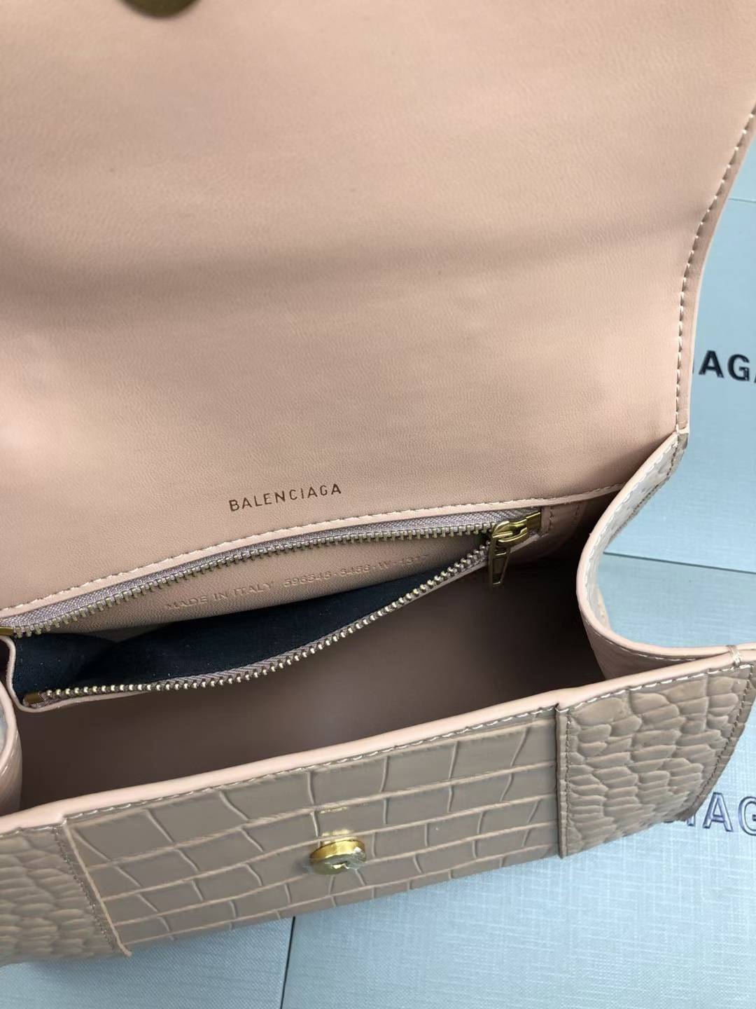 Balenciaga Hourglass handbag likely the Small or XS model, crafted from beige crocodile-embossed leather and featuring the signature B logo plaque